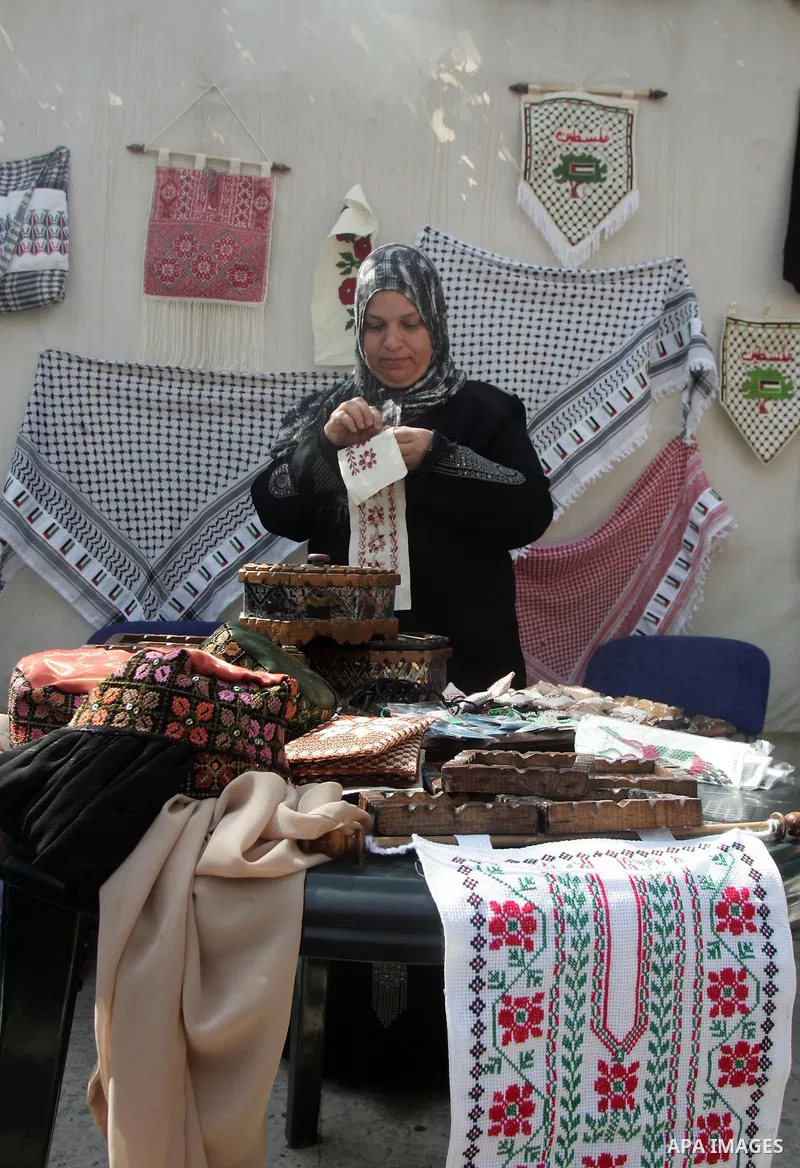 Palestinian women show their home made tradition works during an exhibition in the ocassion of the Mother Day at Jerusalem youth club, in Jerusalem on March 21, 2011. Photo by Mahfouz Abu Turk