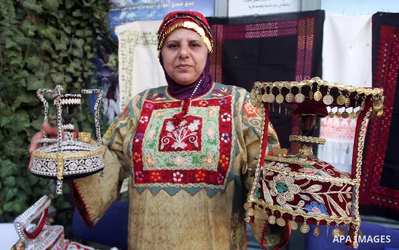 Palestinian women show their home made tradition works during an exhibition in the ocassion of the Mother Day at Jerusalem youth club, in Jerusalem on March 21, 2011. Photo by Mahfouz Abu Turk