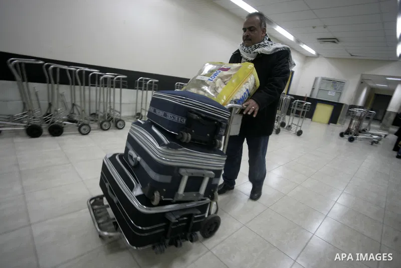 Palestinians arrive at their side of the Rafah border crossing with Egypt in the southern Gaza Strip on March 21, 2011 after some 44 Palestinians struggled to flee the violent rebellion against Libyan leader Moamer Kadha...