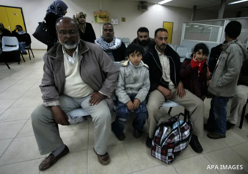 Palestinians arrive at their side of the Rafah border crossing with Egypt in the southern Gaza Strip on March 21, 2011 after some 44 Palestinians struggled to flee the violent rebellion against Libyan leader Moamer Kadha...