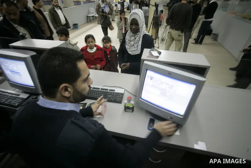 Palestinians arrive at their side of the Rafah border crossing with Egypt in the southern Gaza Strip on March 21, 2011 after some 44 Palestinians struggled to flee the violent rebellion against Libyan leader Moamer Kadha...