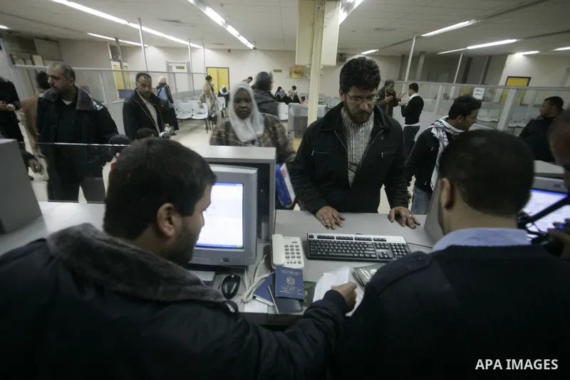 Palestinians arrive at their side of the Rafah border crossing with Egypt in the southern Gaza Strip on March 21, 2011 after some 44 Palestinians struggled to flee the violent rebellion against Libyan leader Moamer Kadha...