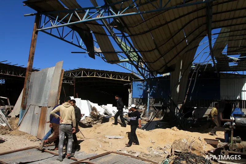 Palestinians inspect a destroyed Hamas compound after an Israeli strike overnight in Gaza City on March 22, 2011 as Israel staged air raids in Gaza overnight, wounding 17 people, Palestinian medics said, after militants...