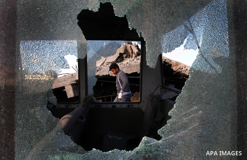Palestinian inspects a destroyed Hamas compound after an Israeli strike overnight in Gaza City on March 22, 2011 as Israel staged air raids in Gaza overnight, wounding 17 people, Palestinian medics said, after militants...