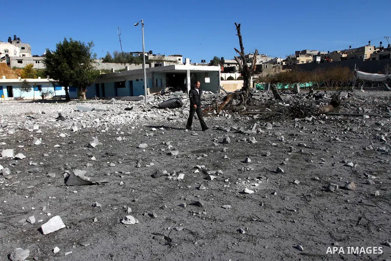 Palestinian Hamas security stand amidst the rubble of a destroyed Hamas compound after its strike by an Israeli war plane overnight in Beit Lahiya town in the northern Gaza Strip on, 22 March 2011. on Feb. 27,2011. Photo...