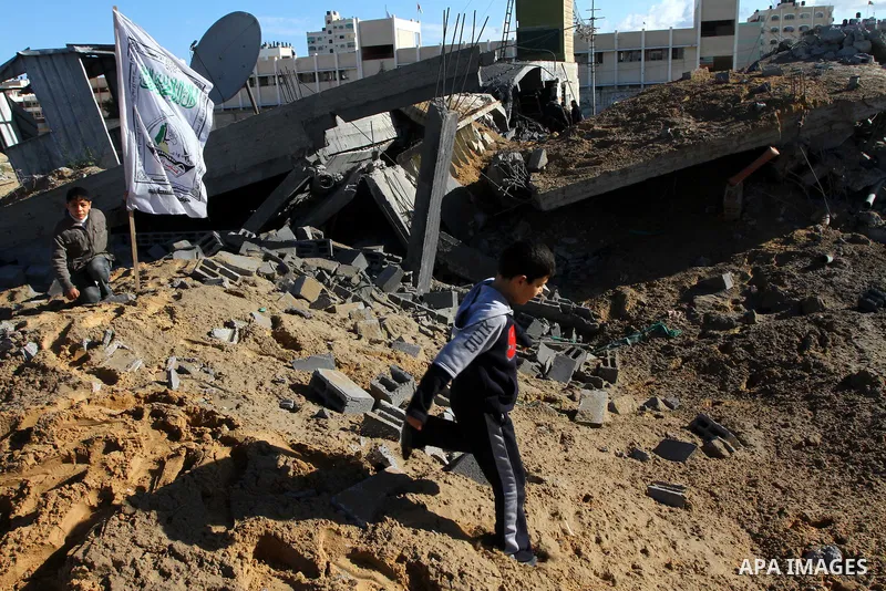 Palestinian inspects a destroyed Hamas compound after an Israeli strike overnight in Gaza City on March 22, 2011 as Israel staged air raids in Gaza overnight, wounding 17 people, Palestinian medics said, after militants...