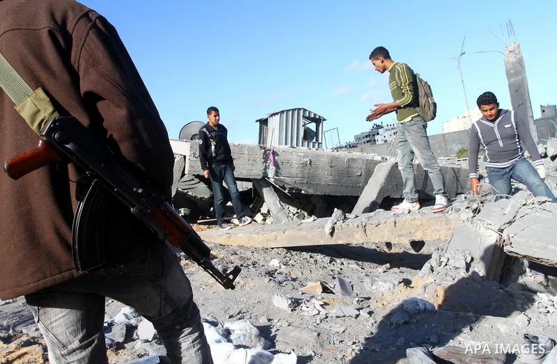 Palestinian inspects a destroyed Hamas compound after an Israeli strike overnight in Gaza City on March 22, 2011 as Israel staged air raids in Gaza overnight, wounding 17 people, Palestinian medics said, after militants...