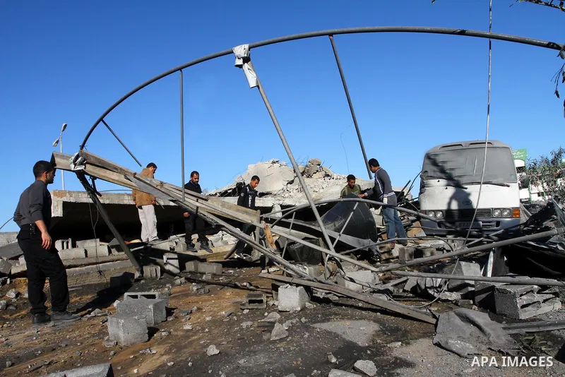 Palestinian inspects a destroyed Hamas compound after an Israeli strike overnight in Gaza City on March 22, 2011 as Israel staged air raids in Gaza overnight, wounding 17 people, Palestinian medics said, after militants...