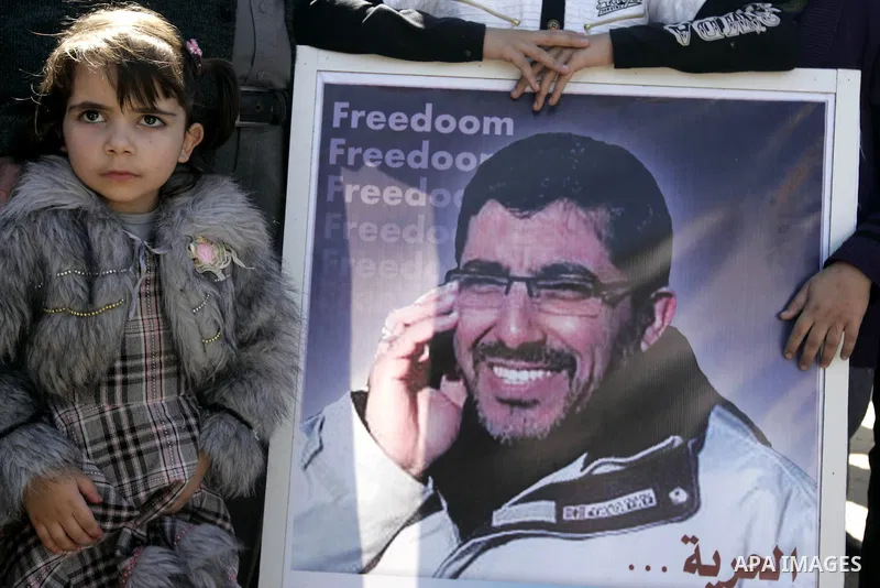 Co-workers and family members of palestinian kidnapped engineer Derar Abu Sissi hold his photos during protest calling for his release in Gaza March 22,2011. Derar Abu sissi was kidnapped by the mossad men in Ukrania on...