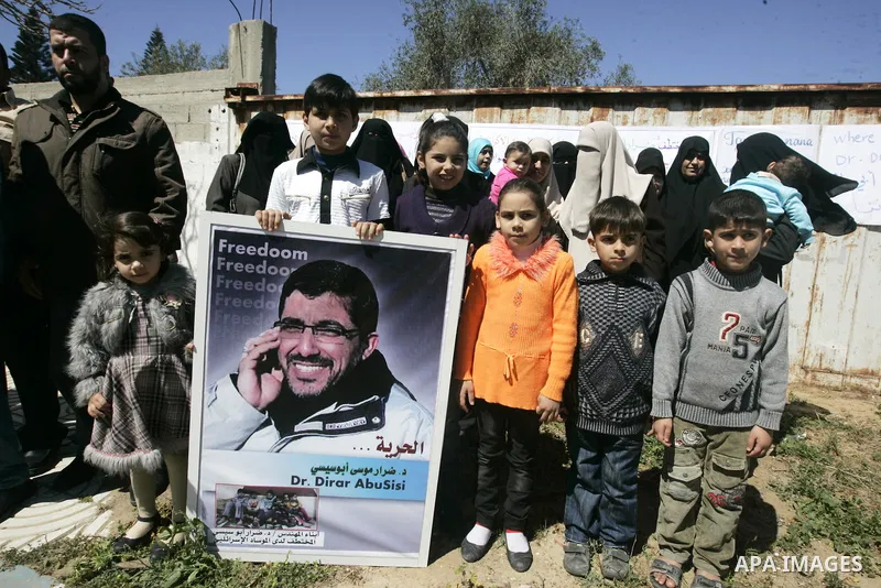 Co-workers and family members of palestinian kidnapped engineer Derar Abu Sissi hold his photos during protest calling for his release in Gaza March 22,2011. Derar Abu sissi was kidnapped by the mossad men in Ukrania on...