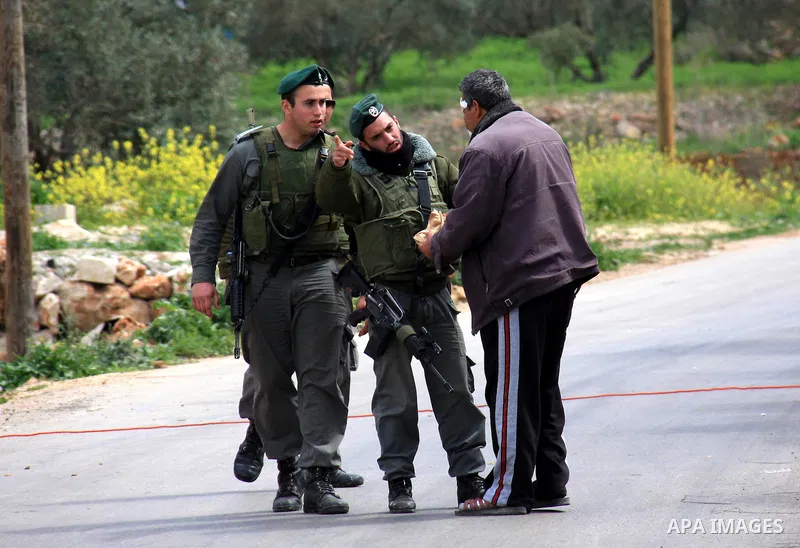 Israeli soldiers stop a Palestinian man, during an operation by the Israeli military in the village of Awarta near the Jewish settlement of Itamar.,the army Impose a curfew in the village in following an attack in a near...