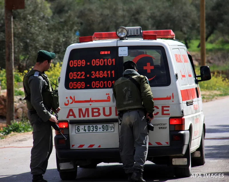 Israeli soldiers check a Palestinian ambulance ,during a military operation searching for suspects in the West Bank village of Awarta near Nablus,the army Imposed a curfew in the village following an attack in a nearby J...