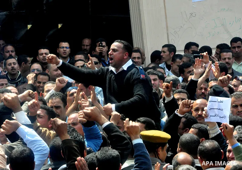 Egyptian police protest in front of the Interior Ministry calling for a raise in their wages in Cairo, Egypt, Tuesday, March 22, 2011. The Arabic on building reads:" Interior Ministry.". Photo by Ahmed Asad