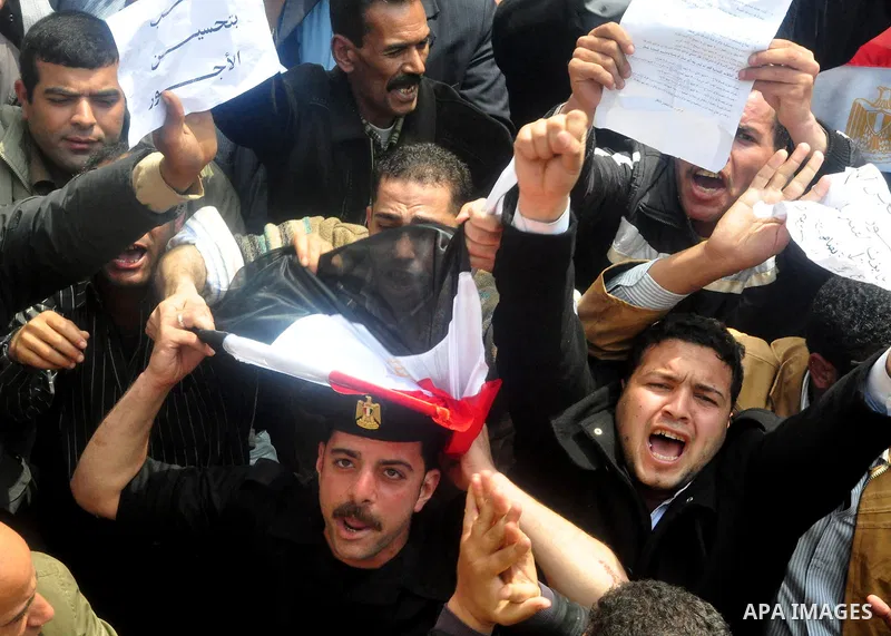 Egyptian police protest in front of the Interior Ministry calling for a raise in their wages in Cairo, Egypt, Tuesday, March 22, 2011. The Arabic on building reads:" Interior Ministry.". Photo by Ahmed Asad