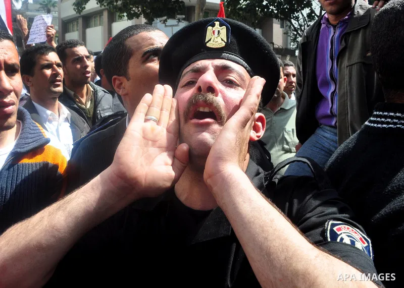 Egyptian police protest in front of the Interior Ministry calling for a raise in their wages in Cairo, Egypt, Tuesday, March 22, 2011. The Arabic on building reads:" Interior Ministry.". Photo by Ahmed Asad