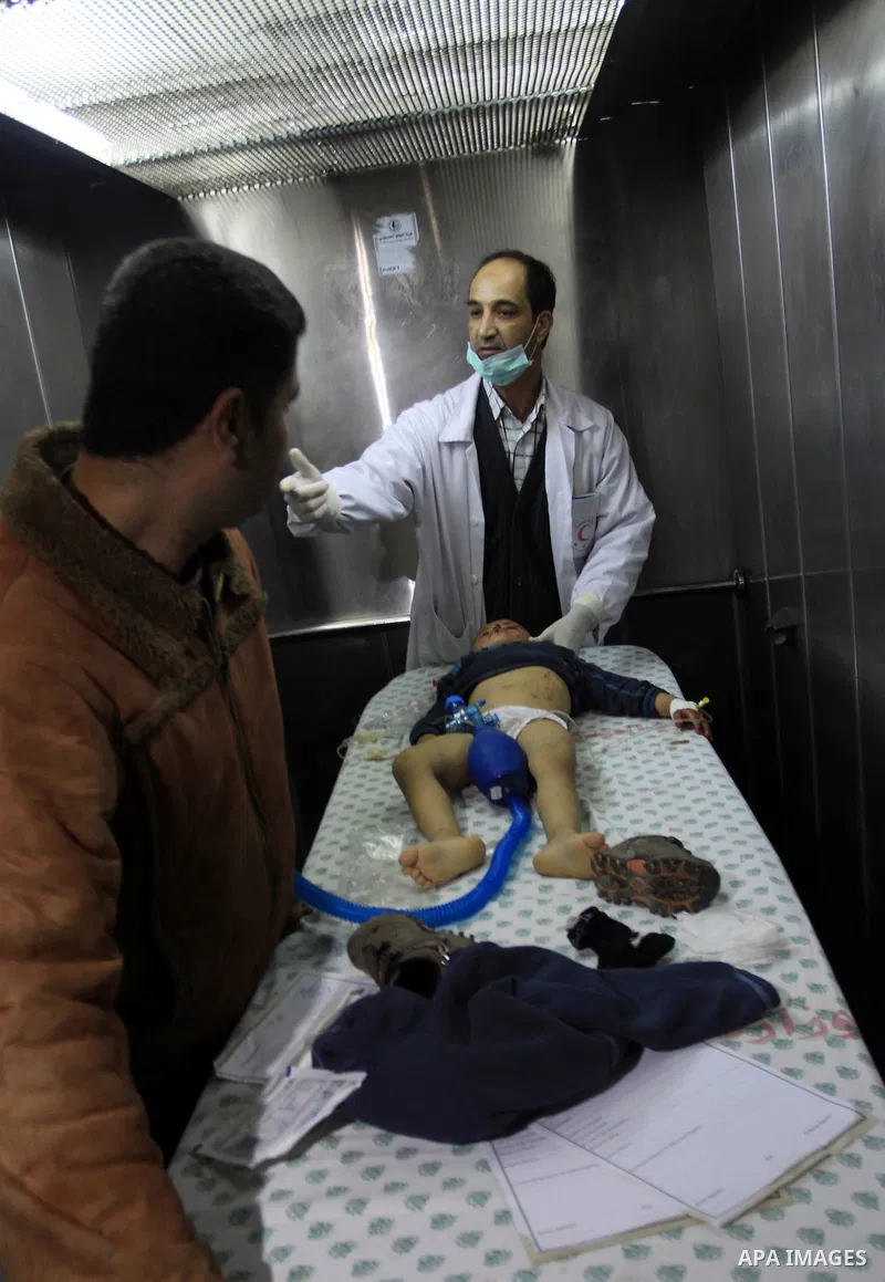 Palestinian medics stand next to a Palestinian injured in an Israeli shells, after was brought to the Shifa hospital in Gaza City, Tuesday, March 22, 2011. Israeli tank fire struck a house in the Gaza Strip on Tuesday, k...