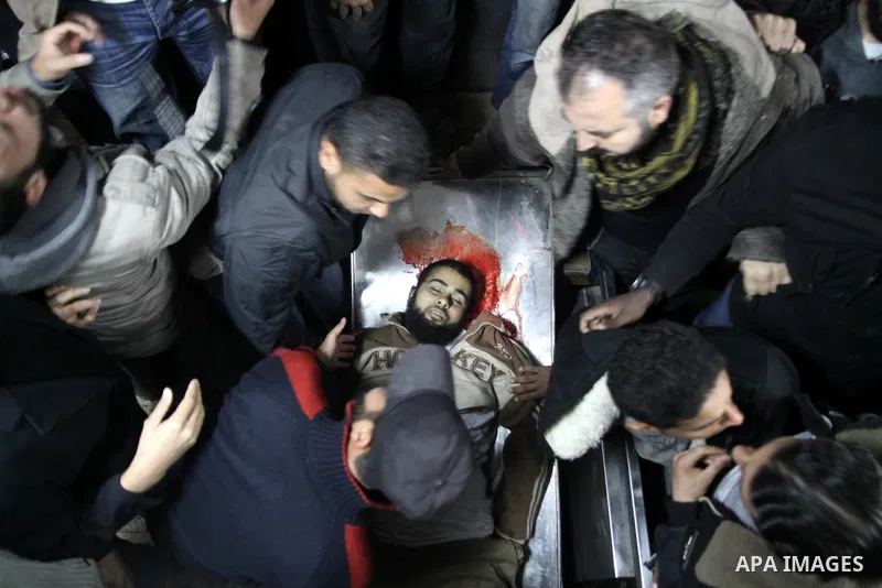 A Palestinian militant killed in an Israeli air strike is deplaced at al-Shifa hospital in Gaza City on March 22, 2011. Three members of the Al Quds Brigades, the armed wing of the radical Islamic Jihad, were killed and...