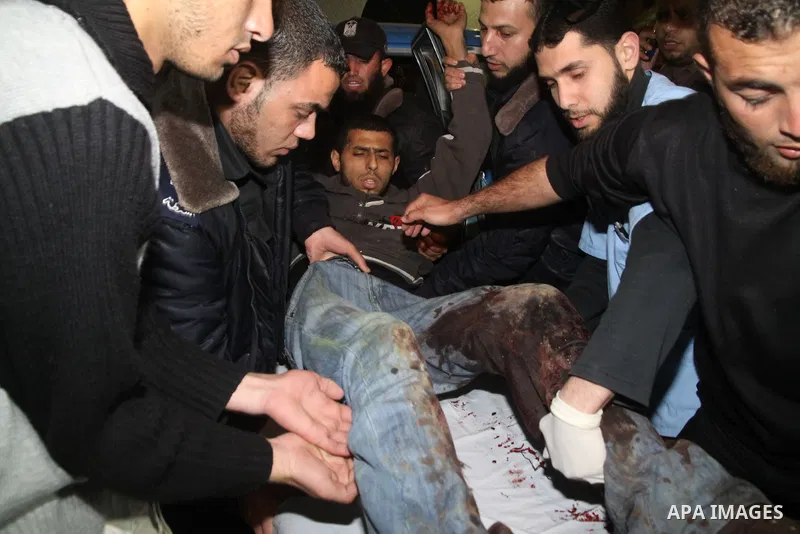 Palestinians carry a wounded man into Al-Shifa hospital in Gaza City, after an Israeli air strike March 22, 2011. The air strike killed four Palestinians militants in Gaza on Tuesday, Hamas officials said after four Pale...