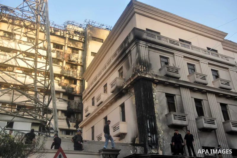 Egyptian firefighters operate on one of the building of the Interior Ministry after a fire erupted, in Cairo, Egypt, 22 March 2011. Egypt's Interior Ministry building was set ablaze by disgruntled police officers on 22 M...