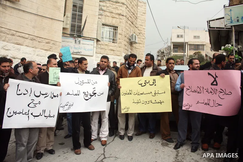 Palestinian teachers take part in a demonstration outside the office of the Directorate of Education in the West Bank city of Hebron on March 23 ,2011. Photo by Najeh Hashlamoun.