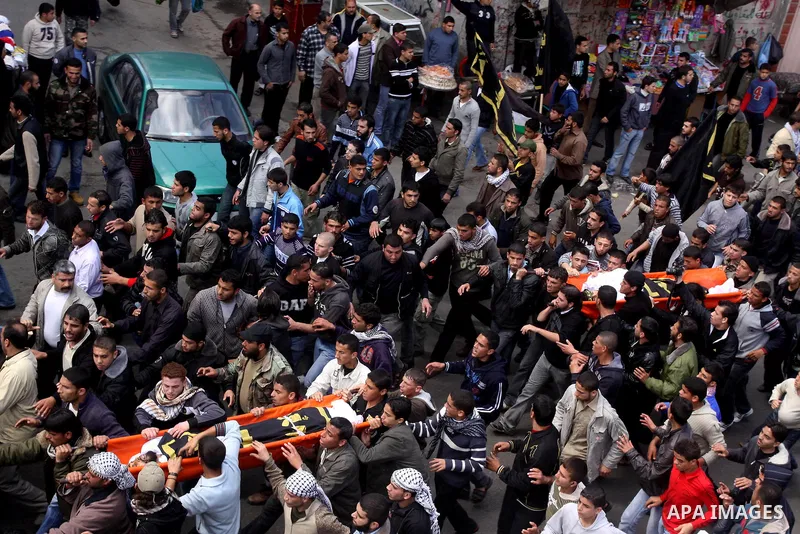 Palestinian mourners carry the bodies of Palestinians during a funeral in Al-Shjaea eastern Gaza City, Gaza Strip, 23 March, 2011 a day after eight Gazans were killed, among them two minors and four militants, as tension...