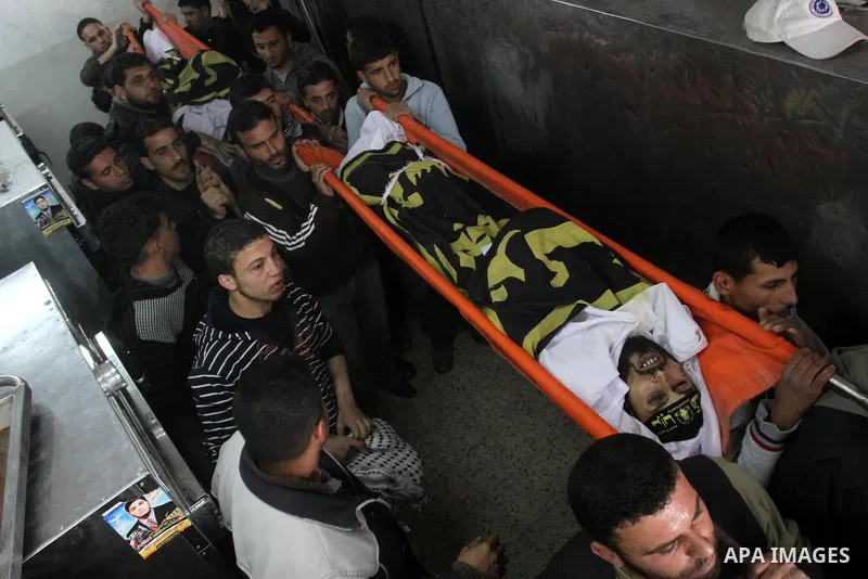 Palestinian mourners carry the bodies of Palestinians during a funeral at a hospital in Gaza City, Gaza Strip, 23 March, 2011 a day after eight Gazans were killed, among them two minors and four militants, as tensions so...