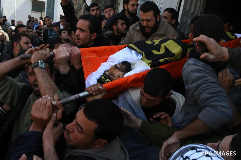 Palestinian mourners carry the bodies of Palestinians during a funeral in Al-Shjaea eastern Gaza City, Gaza Strip, 23 March, 2011 a day after eight Gazans were killed, among them two minors and four militants, as tension...