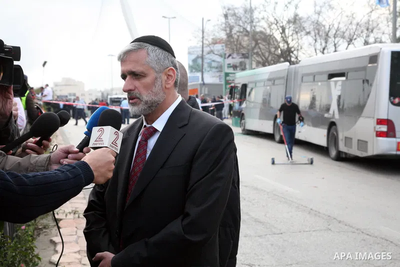 An Israeli official speaks to media at the scene of a bomb attack at a bus station in Jerusalem blowing up next to the bus and near a kiosk, called the 'Explosive Kiosk', on 23 March 2011. Over 30 people were injured by...