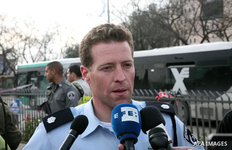 An Israeli official speaks to media at the scene of a bomb attack at a bus station in Jerusalem blowing up next to the bus and near a kiosk, called the 'Explosive Kiosk', on 23 March 2011. Over 30 people were injured by...