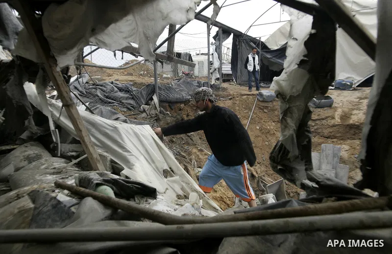 Palestinian boy surveys the damage after an Israeli air strike on a smuggling tunnel in the southern Gaza Strip, along the Gaza-Egypt border March 24, 2011. Israeli aircraft struck targets in the Gaza Strip on Thursday,...