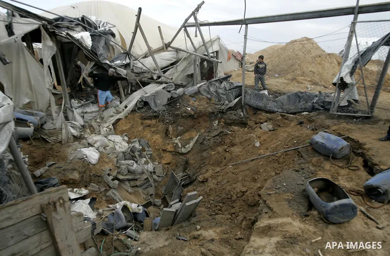 Palestinian boy surveys the damage after an Israeli air strike on a smuggling tunnel in the southern Gaza Strip, along the Gaza-Egypt border March 24, 2011. Israeli aircraft struck targets in the Gaza Strip on Thursday,...