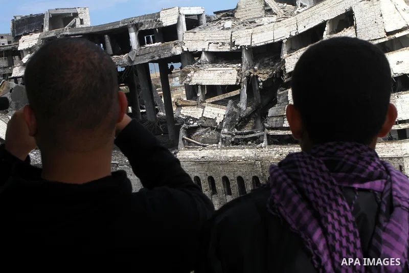 Palestinians observe the destroyed security office in Gaza City, on March 25, 2011, as Israeli aircraft attacked four targets in the Gaza Strip during the night, lightly wounding three people, in response to Palestinian...