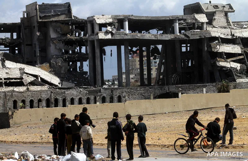 Palestinians observe the destroyed security office in Gaza City, on March 25, 2011, as Israeli aircraft attacked four targets in the Gaza Strip during the night, lightly wounding three people, in response to Palestinian...