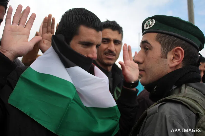 Protesters argue with an Israeli soldier during a demonstration against Israel's controversial separation barrier in the West Bank village of Maasarah, near the biblical town of Bethlehem on March 25, 2011.Israel says th...