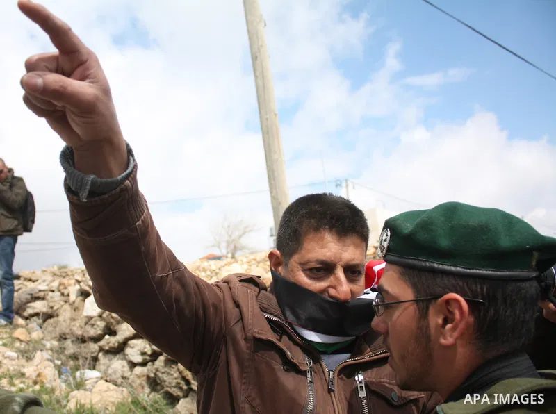 Protesters argue with an Israeli soldier during a demonstration against Israel's controversial separation barrier in the West Bank village of Maasarah, near the biblical town of Bethlehem on March 25, 2011.Israel says th...