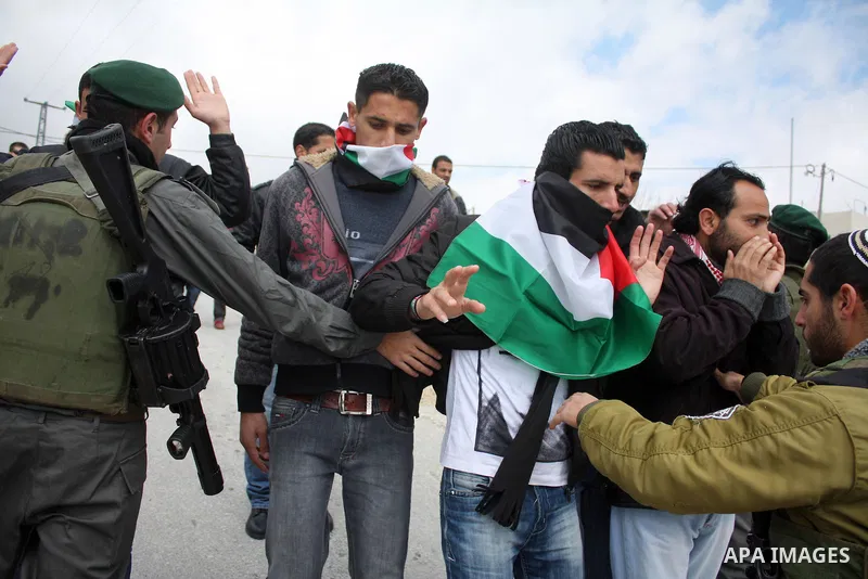Protesters argue with an Israeli soldier during a demonstration against Israel's controversial separation barrier in the West Bank village of Maasarah, near the biblical town of Bethlehem on March 25, 2011.Israel says th...