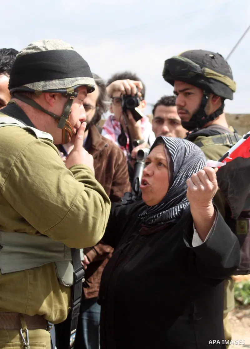 Protesters argue with an Israeli soldier during a demonstration against Israel's controversial separation barrier in the West Bank village of Maasarah, near the biblical town of Bethlehem on March 25, 2011.Israel says th...
