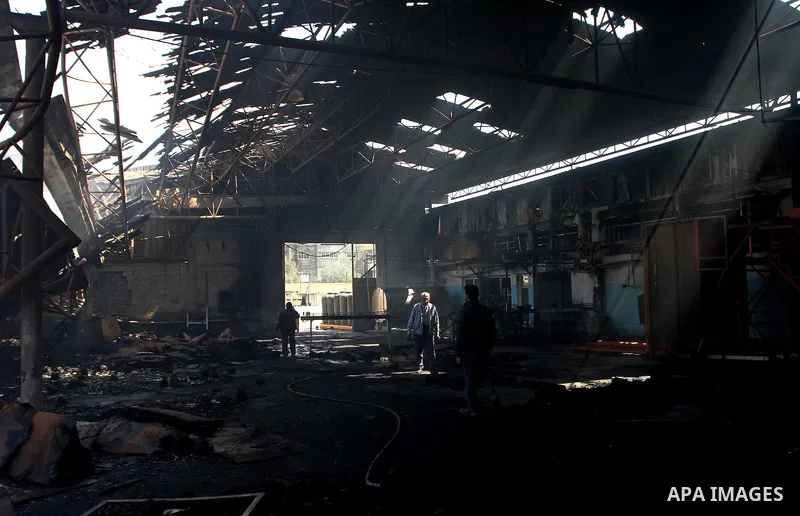 Palestinians observe the damage in a soft drinks factory after an explosion earlier on March 26, 2011 in the Zeitun neighbourhood of Gaza city. Despite Israel military said none of its forces were operating in the area,...