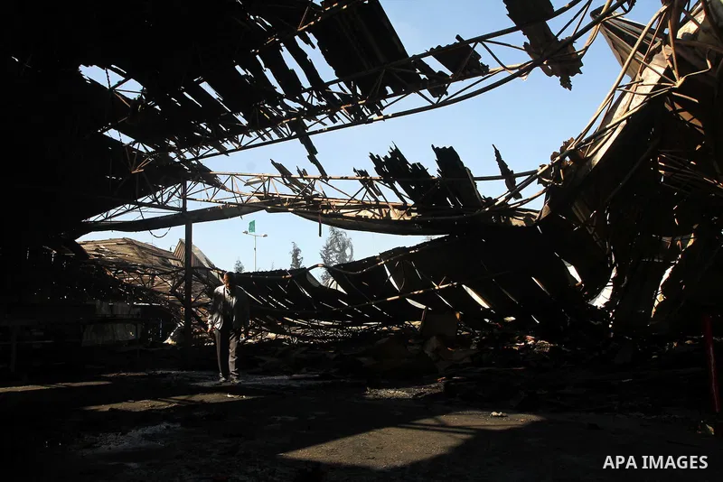 Palestinians observe the damage in a soft drinks factory after an explosion earlier on March 26, 2011 in the Zeitun neighbourhood of Gaza city. Despite Israel military said none of its forces were operating in the area,...