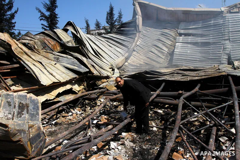 Palestinians observe the damage in a soft drinks factory after an explosion earlier on March 26, 2011 in the Zeitun neighbourhood of Gaza city. Despite Israel military said none of its forces were operating in the area,...