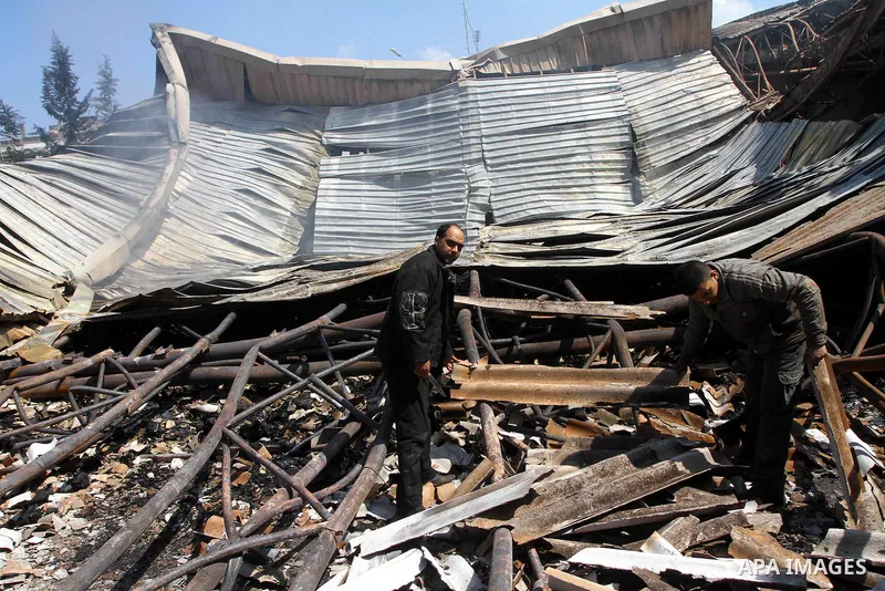 Palestinians observe the damage in a soft drinks factory after an explosion earlier on March 26, 2011 in the Zeitun neighbourhood of Gaza city. Despite Israel military said none of its forces were operating in the area,...