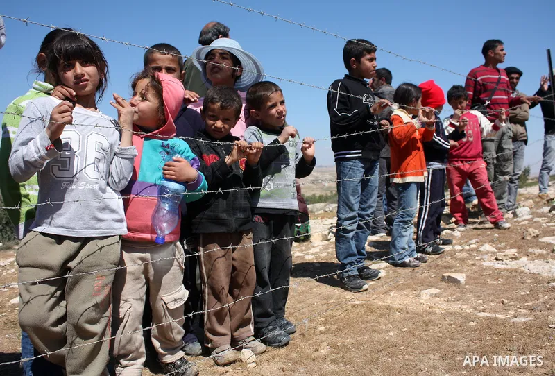 Palestinian children take part in a protest against Jewish settlers in the West Bank village of Yatta, south of the West Bank city of Hebron, on 26 March 2011.Photo by Najeh Hahlamoun