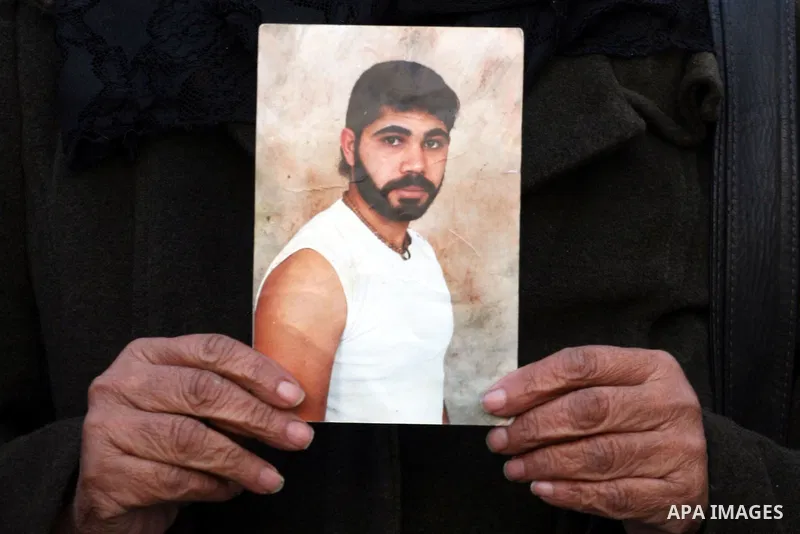 Palestinians hold pictures of their prisoned relatives in Israeli jails as they gather in a protest calling for their liberty in the West Bank city of Ramallah on March 26,2011. Photo by Issam Rimawi