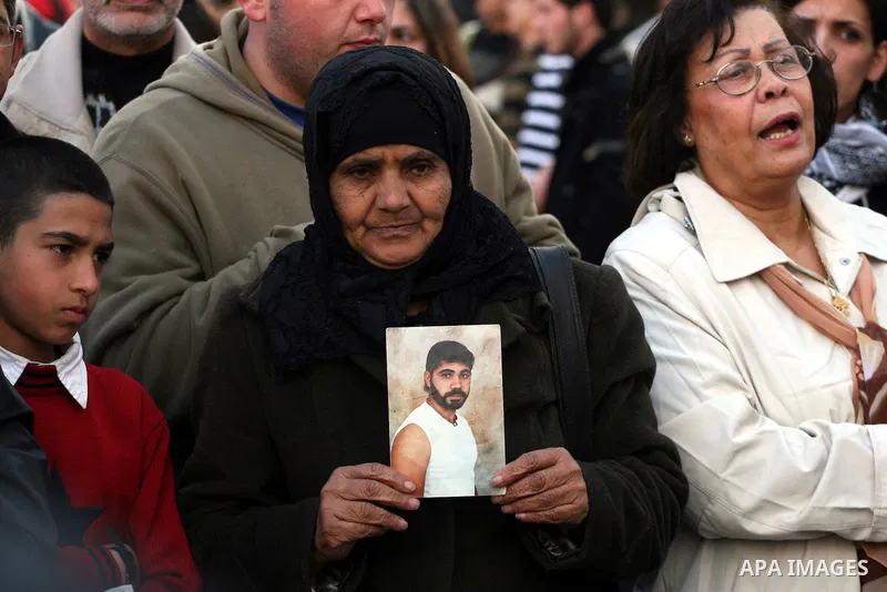 Palestinians hold pictures of their prisoned relatives in Israeli jails as they gather in a protest calling for their liberty in the West Bank city of Ramallah on March 26,2011. Photo by Issam Rimawi