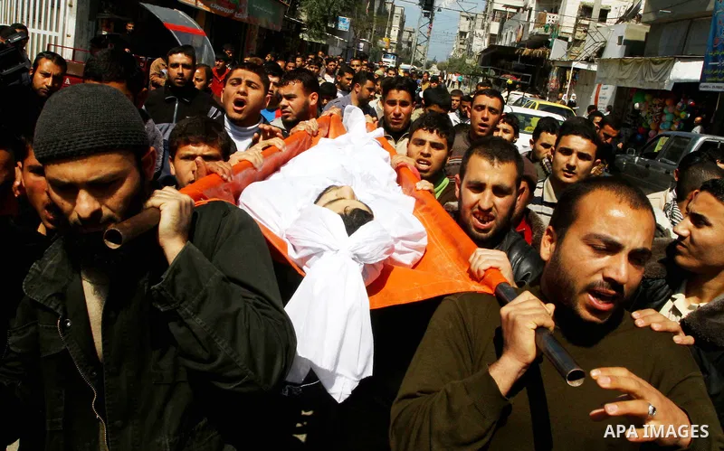Relatives carry the body of Islamic Jihad militant Sabri Asaliah during his funeral in Jabalia city in the Gaza Strip, on March 27, 2011. An Israeli air strike killed two Gaza militants, threatening to prompt more tit-fo...