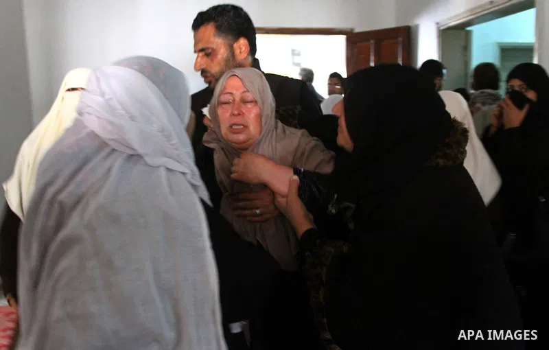 Relatives of Saber Assalya, an Islamic Jihad militant, mourn during his funeral in Jabalya refugee camp, northern Gaza Strip, Sunday, March 27, 2011. Israeli aircraft struck a Palestinian rocket squad in the Gaza Strip o...