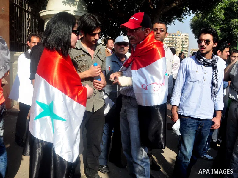 Syrians living in Egypt demonstrate against the recent actions of the Syrian government and in support of protesters, outside the Arab League headquarters in Cairo, Egypt Sunday, March 27, 2011. Syrian army units deploye...