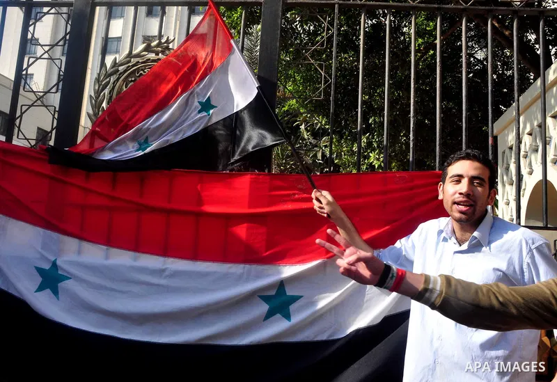 Syrians living in Egypt demonstrate against the recent actions of the Syrian government and in support of protesters, outside the Arab League headquarters in Cairo, Egypt Sunday, March 27, 2011. Syrian army units deploye...