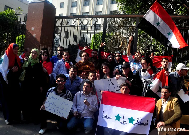 Syrians living in Egypt demonstrate against the recent actions of the Syrian government and in support of protesters, outside the Arab League headquarters in Cairo, Egypt Sunday, March 27, 2011. Syrian army units deploye...