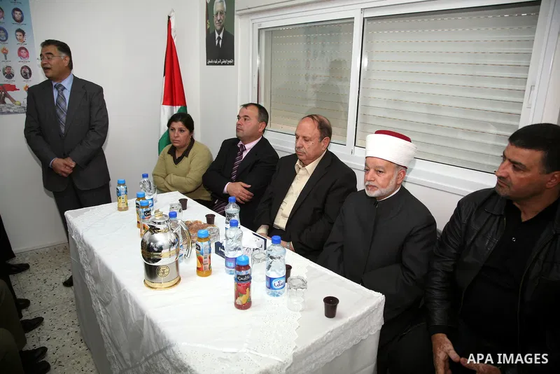Palestinians attend the opening of the headquarters of the National Alliance for the families of the martyrs in Al-Ram in the West Bank March 27,2011. Sliman Khader